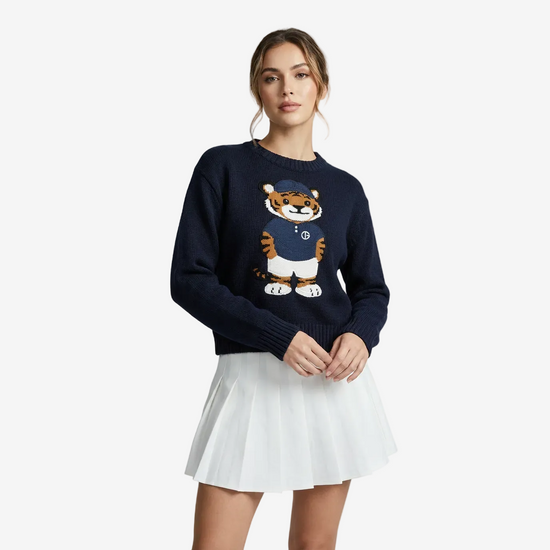 Woman wearing a navy sweater with a tiger design on a white background