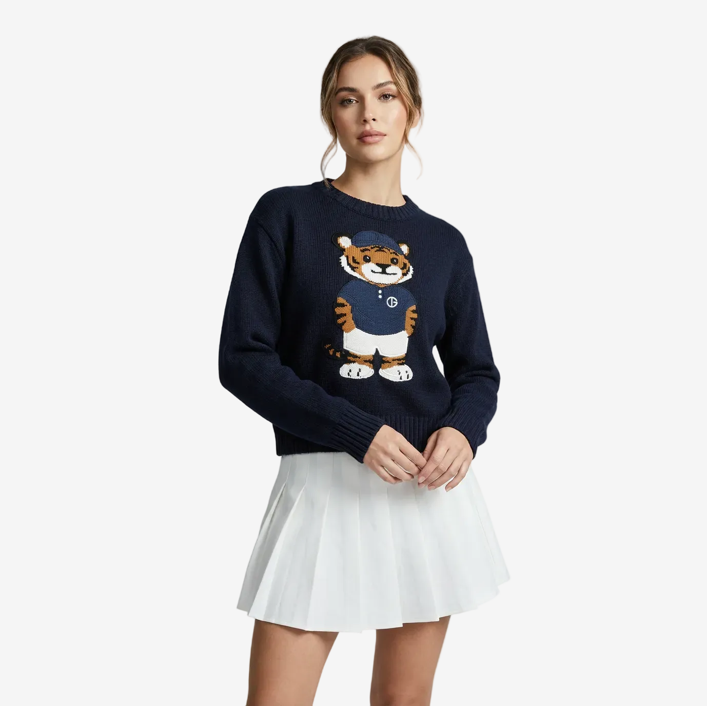 Woman wearing a navy sweater with a tiger design on a white background